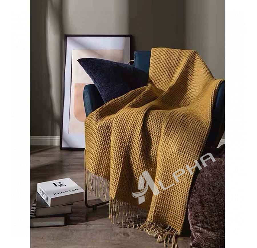 Yellow fringed knitted cotton blanket